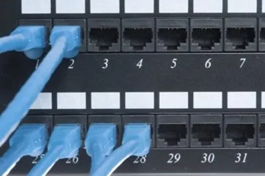 Patch Panel Black patch panel with labeled Ethernet ports numbered 1 to 28.