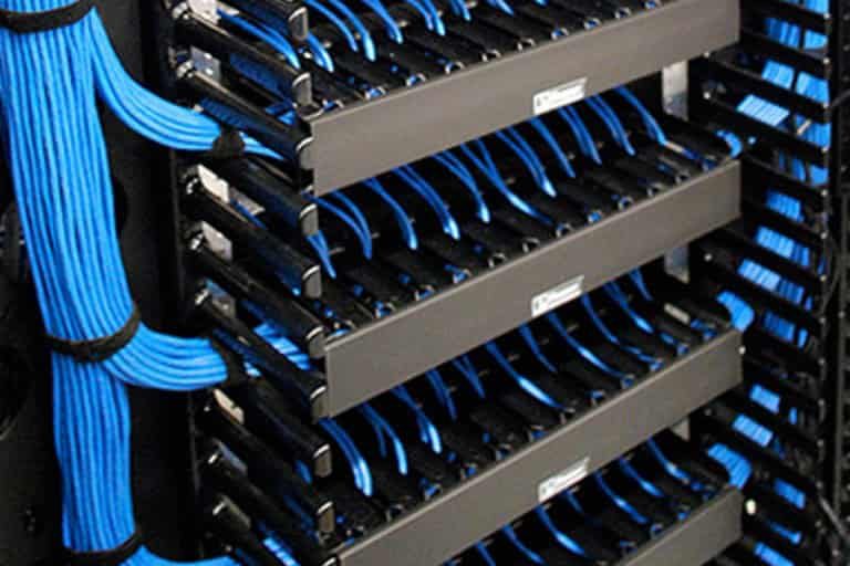 ethernet cables Blue network cables neatly organized in racks with labeled connectors.